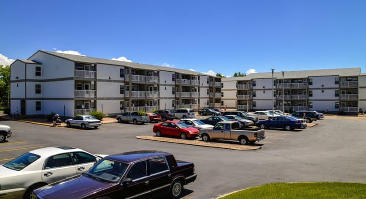 Exterior view of Birchwood Manor Senior Apartments with parked cars