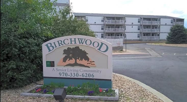Exterior view of Birchwood Manor Senior Apartments sign and building