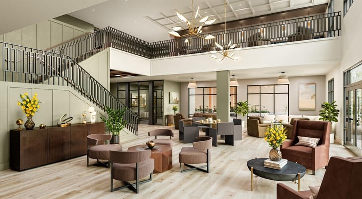 Modern lobby featuring seating areas and decorative plants.