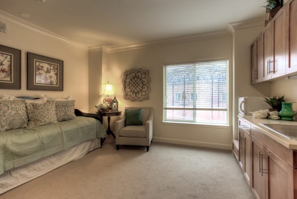 Cozy interior of a private resident room with a bed and seating area