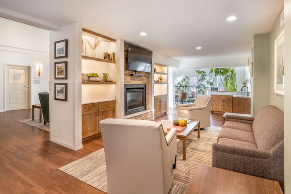 A cozy living room with comfortable seating and a fireplace.