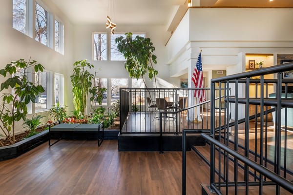 Bright common area with plants and American flag