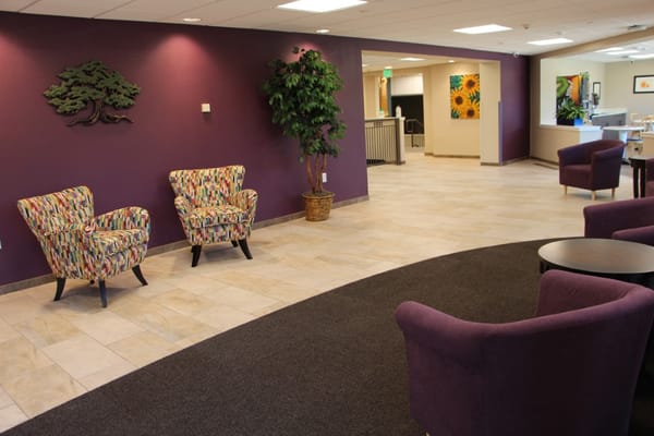 Common area with colorful chairs and purple walls