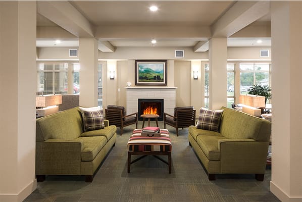 Cozy common area with seating around a fireplace