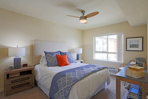 Cozy resident room with a queen bed and window