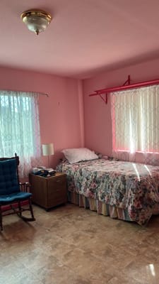 Cozy pink resident room with floral bedding
