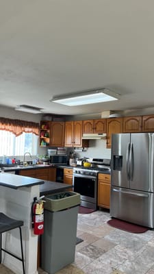 Interior kitchen space with wooden cabinets and appliances