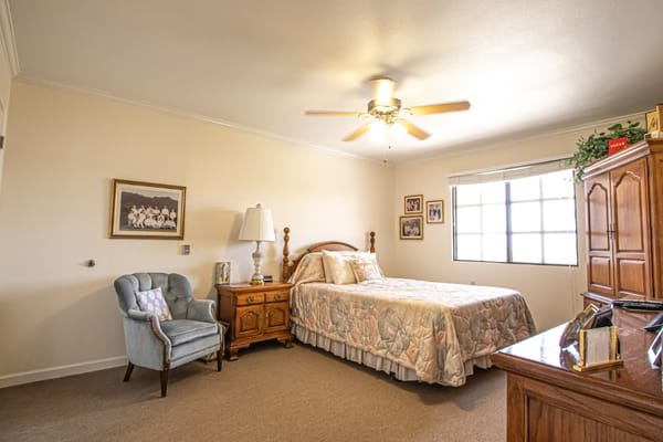 Cozy private bedroom with a bed and chair