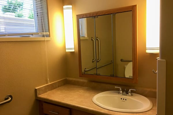 Bathroom sink with mirror in a well-lit area