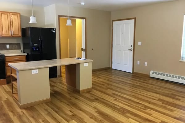 Interior view of a resident apartment with kitchen and living area