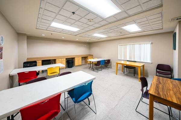 Bright interior view of a common area with tables and chairs