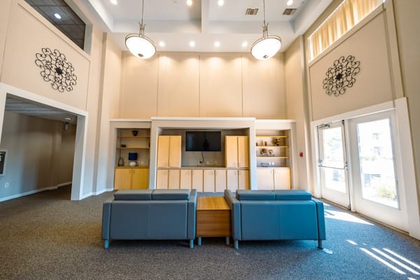 Bright, spacious interior common area with seating