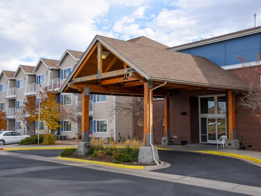 Covered entrance of a senior living facility with parking