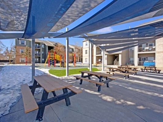 Outdoor recreational area with shaded picnic tables