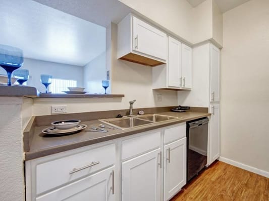 Bright kitchen area with modern cabinets and appliances