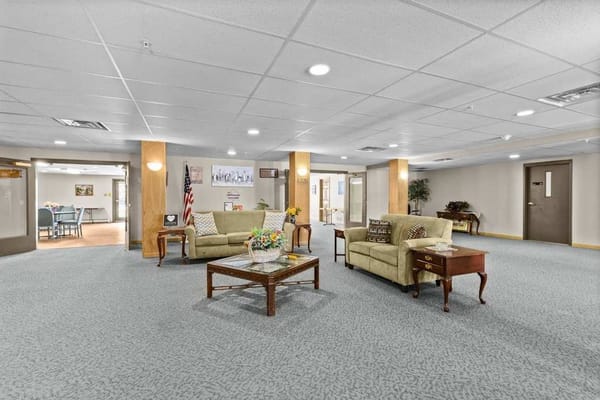 Lounge area with seating and decorative table in Town Centre Senior Apartments.