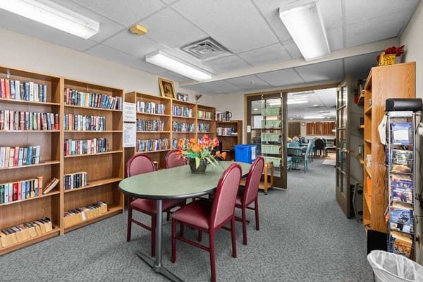 A cozy library with bookshelves and a reading area