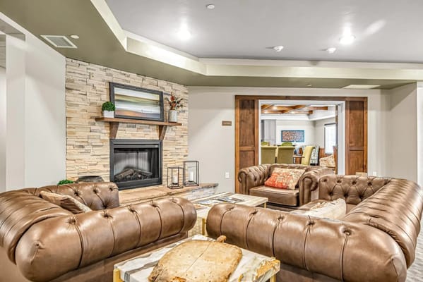Inviting lounge area with leather sofas and a fireplace