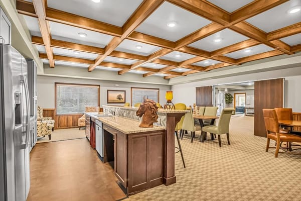 Kitchen and common area with seating and artwork