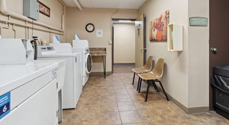 Laundry room with washers and dryers at Grant Street Senior Apartments