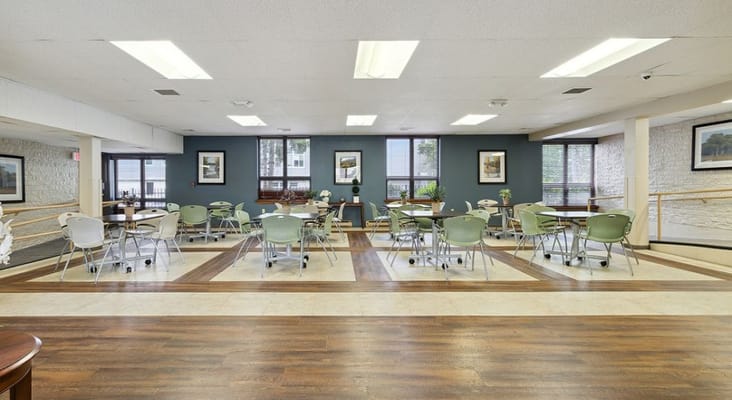Spacious common area with tables and chairs in Grant Street Senior Apartments