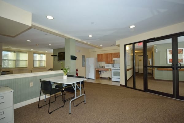 Spacious common area with seating and kitchen amenities