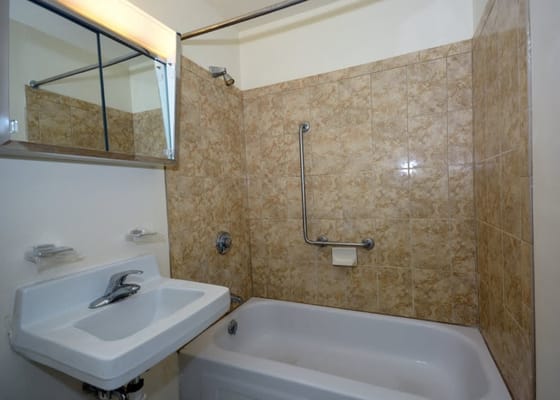 Small bathroom featuring a bathtub and sink