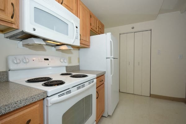 Kitchen with stove, microwave, and refrigerator