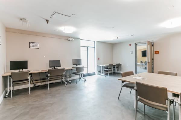 Bright interior space with computers and tables