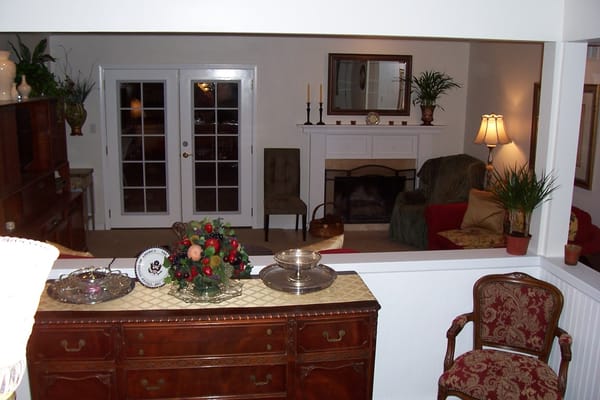 A welcoming living room with a fireplace, tasteful decor, and seating areas