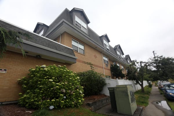 Exterior of Life Manor Independent Living facility with landscaped bushes