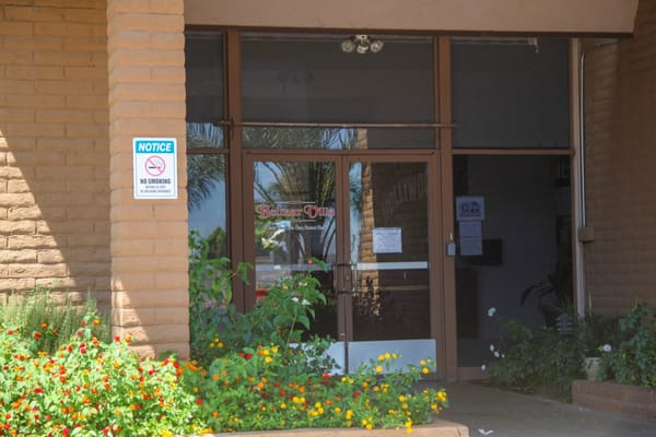 Entrance of Belmar Villa Assisted Living with flowers