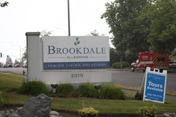 Facility sign for Brookdale Allenmore on a street