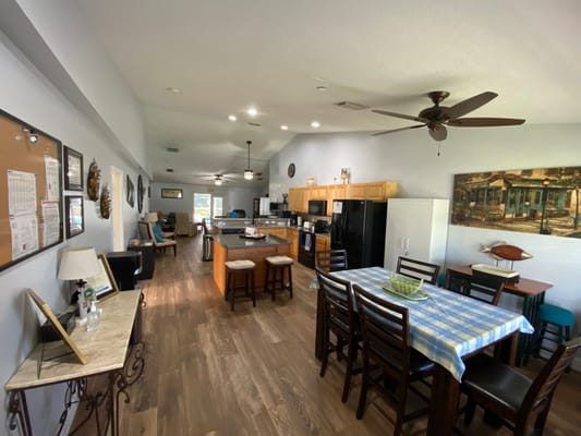 Spacious common area with residents relaxing and dining