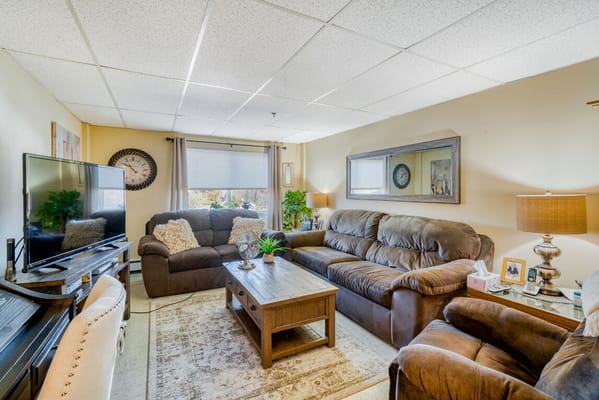 Comfortable living room with couches and a TV