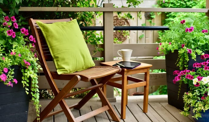 Outdoor seating area with vibrant flowers and greenery