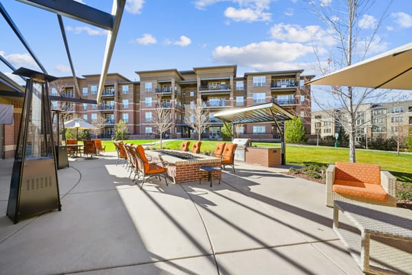 Outdoor seating area with fire pit and sunny landscaping