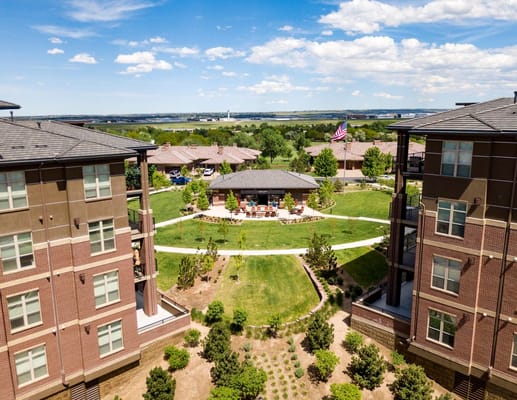 Aerial view of a senior living facility with gardens