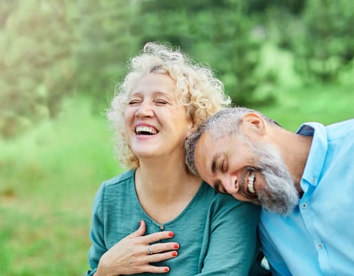 Smiling couple enjoying time outdoors in a green space