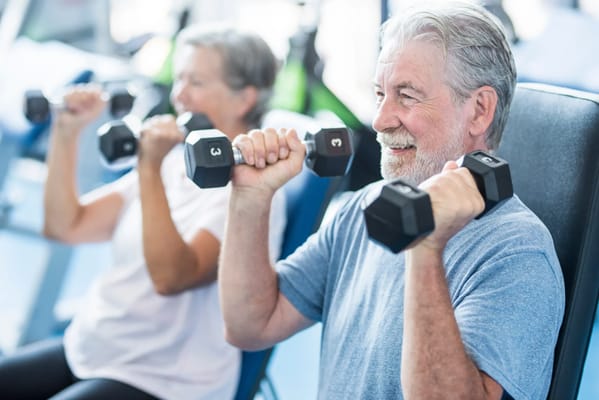Seniors exercising with dumbbells in a gym
