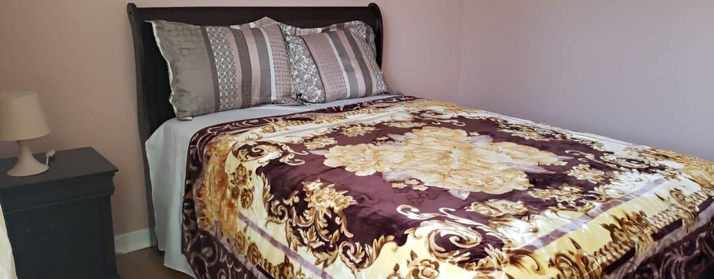 Cozy bedroom with a patterned blanket and pillows