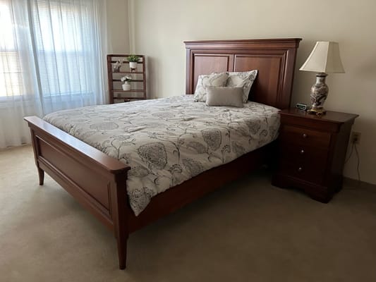 Inviting bedroom with a queen-size bed and bedside lamp.