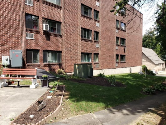 Exterior view of Danbury Tower featuring a garden and seating area.