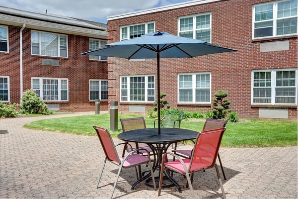 Outdoor seating area with table and umbrella