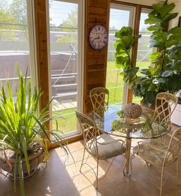 Cozy sunlit sitting area with plants and a table