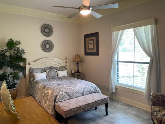 A cozy resident room with a bed and seating