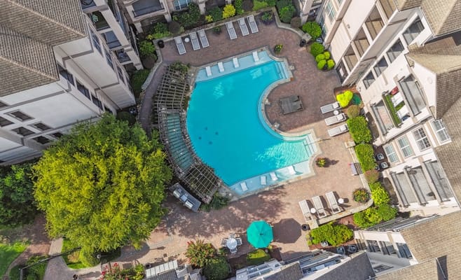 Aerial view of a swimming pool area surrounded by buildings
