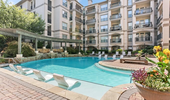 Swimming pool area with chairs and flowers