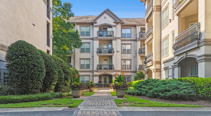 Exterior view of a senior living facility surrounded by greenery