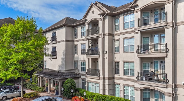 Exterior view of Avana Uptown facility with trees and parking